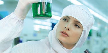 Researcher looking at vials