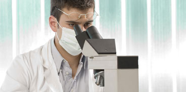 Researcher using the microscope