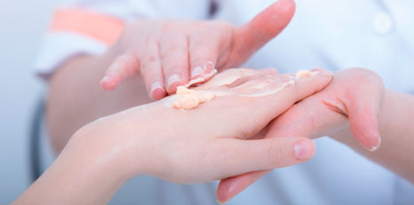 Applying cream on a woman's hand